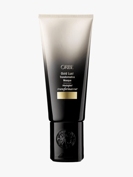 Oribe Gold Lust Transformative Hair Mask in gold and black branded tube component on a light gray background