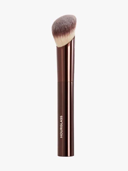 Hourglass Ambient Soft Glow Foundation Brush foundation brush with brown chrome handle and white and brown bristles on light gray background