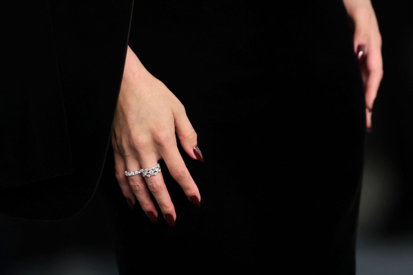 Selena Gomez wears a dark burgundy manicure to a gala.